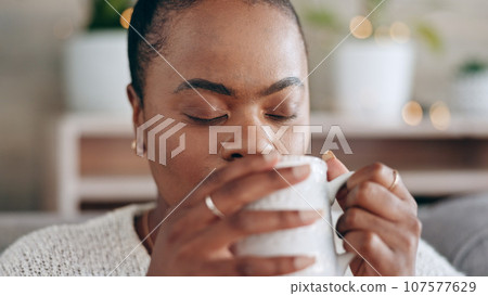 Black woman, meditation and peace with coffee in hands and relax at home, future and mindfulness. Stress free, warm drink and dream, inspiration and self care, calm in lounge and tea for wellness 107577629