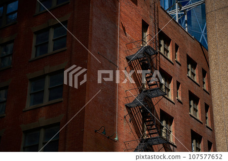 Old fire escape on an old brick wall. American vintage style. 107577652
