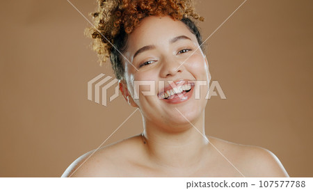 Face, skincare and beauty of happy woman in studio isolated on a brown background. Portrait, smile of model and natural cosmetics in spa facial treatment, wellness and healthy skin for dermatology 107577788