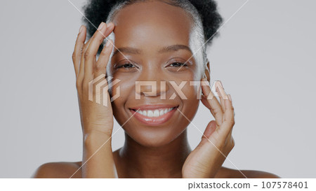 Face touch, skincare and beauty of black woman in studio isolated on gray background for dermatology. Portrait, hands and natural cosmetics of happy model in spa facial treatment, wellness or health 107578401