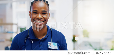 Black man, doctor and smile on face in clinic for healthcare services, excited or happy for job. African medic, male nurse and happiness in portrait for wellness service, medical career or workplace 107578438