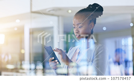 Business woman, phone and office window for marketing communication, social media and company email in reflection. African worker typing on mobile for professional chat, contact or search information 107578457