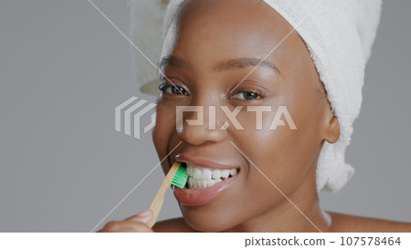 Portrait, black woman with toothbrush for teeth whitening and dental, health and wellness isolated on grey background. Oral hygiene, orthodontics and clean plaque away with morning routine in studio Portrait, black woman with toothbrush for teeth whitening and dental, health and wellness isolated on grey background. Oral hygiene, orthodontics and clean plaque away with morning routine in studio 107578464
