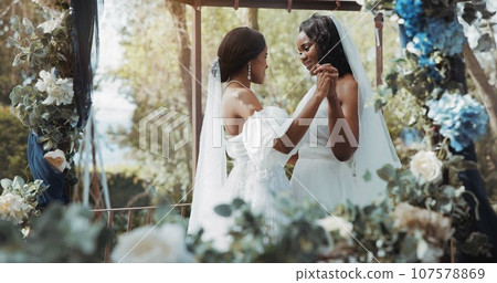 Lesbian, wedding and dance in garden for celebration or love for diversity or commitment, outside and dress. Black women, married and happy with trust for event or romance, ceremony for partnership Lesbian, wedding and dance in garden for celebration or love for diversity or commitment, outside and dress. Black women, married and happy with trust for event or romance, ceremony for partnership 107578869