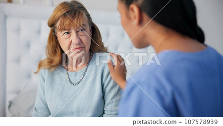 Comfort, conversation and nurse with a senior woman after a cancer diagnosis in retirement home. Healthcare, consultation and elderly female patient listening to doctor at medical checkup in bedroom. Comfort, conversation and nurse with a senior woman after a cancer diagnosis in retirement home. Healthcare, consultation and elderly female patient listening to doctor at medical checkup in bedroom. 107578939