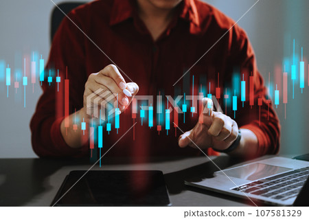 Attractive young european business using laptop and tablet with abstract forex chart. Investment and economy concept.. 107581329