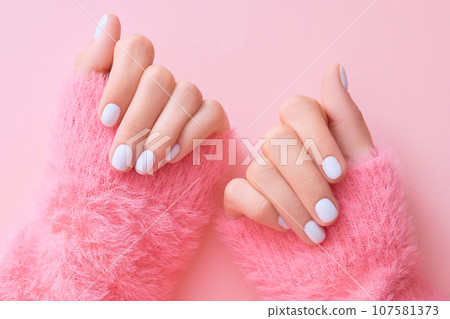 Close up womans hands with white manicure 107581373