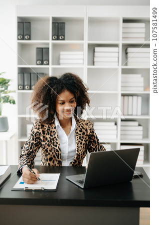 Business woman using tablet and laptop for doing math finance on an office desk, tax, report, accounting, statistics, and analytical research concept in office Business woman using tablet and laptop for doing math finance on an office desk, tax, report, accounting, statistics, and analytical research concept in office 107581499