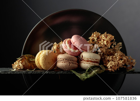 Macaroons with dried flowers. Macaroons with dried flowers. 107581836
