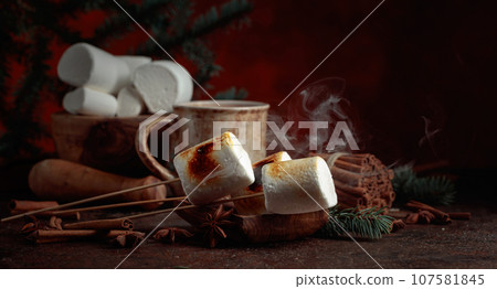 Toasted marshmallows on an old brown table. Toasted marshmallows on an old brown table. 107581845