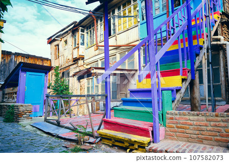 Multi-colored wooden stairway of old georgian house Multi-colored wooden stairway of old georgian house 107582073