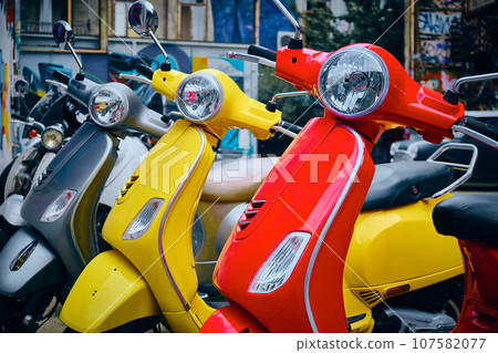 Three colorful scooters Three colorful scooters 107582077