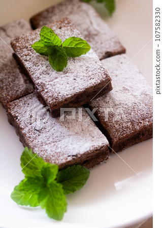 Brownie (chocolate cake) and mint Brownie (chocolate cake) and mint 107582330