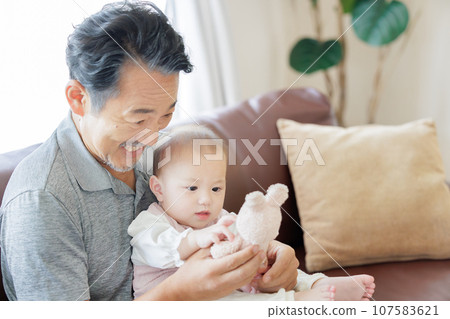 Grandfather and grandson playing with dolls 107583621