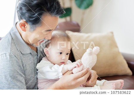 Grandfather and grandson playing with dolls 107583622