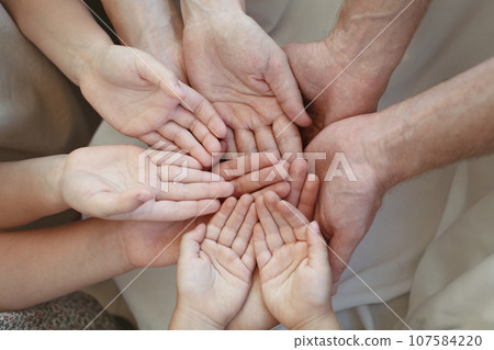 Human hands, many people holding empty space on hand together Human hands, many people holding empty space on hand together 107584220