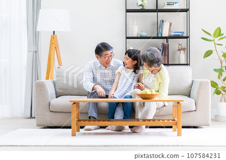 A senior couple with their granddaughter 107584231