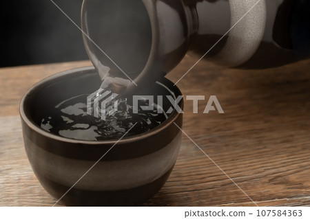 pour hot sake pour hot sake 107584363