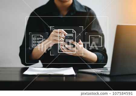 E-document management Paperless workplace, e-signing, electronic signature, document management. businessman signs an electronic document on a virtual notebook screen using a stylus pencil. . E-document management Paperless workplace, e-signing, electronic signature, document management. businessman signs an electronic document on a virtual notebook screen using a stylus pencil. . 107584591