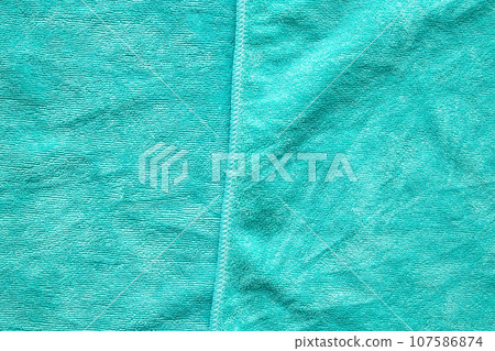 Green towel fabric texture surface close up background Green towel fabric texture surface close up background 107586874