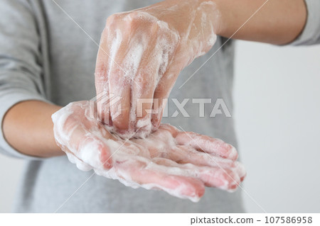Man wash hands with soap for COVID-19 corona virus prevention concept Man wash hands with soap for COVID-19 corona virus prevention concept 107586958