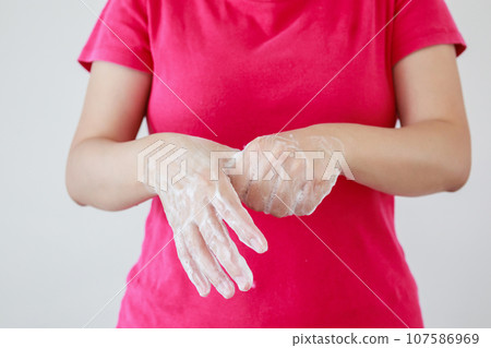 Woman washing hands with soap for COVID-19 corona virus prevention concept 107586969