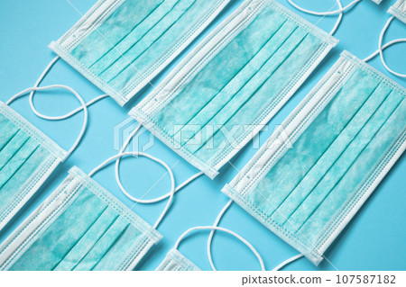Surgical face mask on blue background protection against COVID-19 coronavirus. Healthcare and medical concept 107587182
