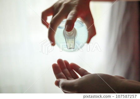 Woman using alcohol sanitizer gel rub for cleaning hand COVID-19 corona virus prevention concept Woman using alcohol sanitizer gel rub for cleaning hand COVID-19 corona virus prevention concept 107587257