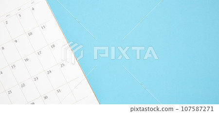 calendar page close up on blue background business planning appointment meeting concept 107587271