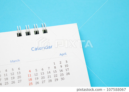 calendar page close up on blue background business planning appointment meeting concept 107588067