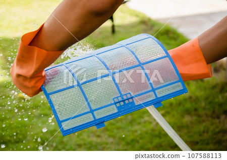 Asian man cleaning air conditioner dirty filter Asian man cleaning air conditioner dirty filter 107588113