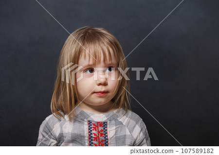 Cheerful little child girl on blackboard background 107589182