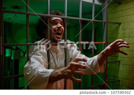 Mentally ill male patient with attack of rabies locked in cage ward Mentally ill male patient with attack of rabies locked in cage ward 107590302