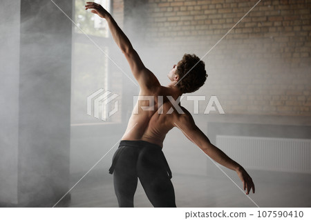 Handsome shirtless man ballet dancer making dance element 107590410