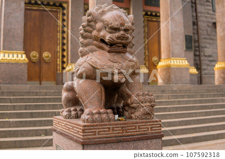 stone statue of a lion at the entrance to the Buddhist datsan Gunzechoinei stone statue of a lion at the entrance to the Buddhist datsan Gunzechoinei 107592318