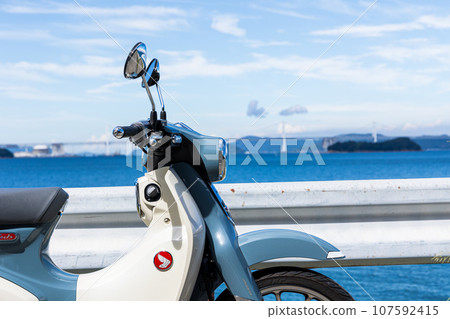 Motorcycle parked by the sea 107592415