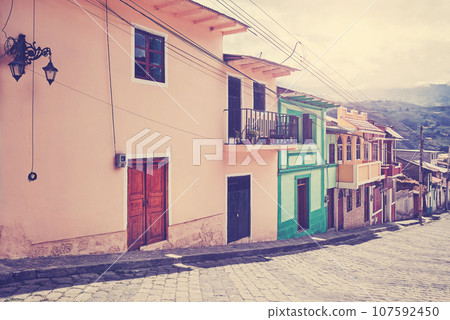 Empty street with old colonial buildings, retro toning applied, Ecuador. 107592450