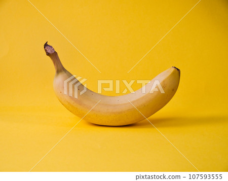 One ripe banana isolated on yellow One ripe banana isolated on yellow 107593555