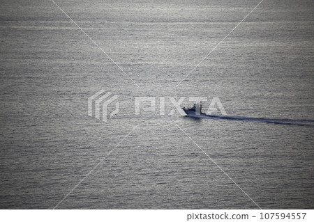 A boat sailing on a calm sea A boat sailing on a calm sea 107594557