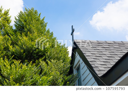 Christ church modern building with roof shingles material roof tiles exterior outdoor with big green tree Christ church modern building with roof shingles material roof tiles exterior outdoor with big green tree 107595793