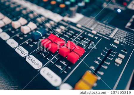 Sound mixer or concert sound engineer, closeup studio motorized volume level control sliders stero split channel device Sound mixer or concert sound engineer, closeup studio motorized volume level control sliders stero split channel device 107595819