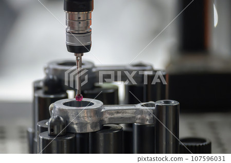 The CMM machine measuring the connecting rod parts. 107596031