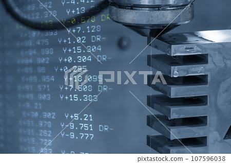 Abstract scene the wire EDM machine cutting the mold insert parts and G-code data background. Abstract scene the wire EDM machine cutting the mold insert parts and G-code data background. 107596038