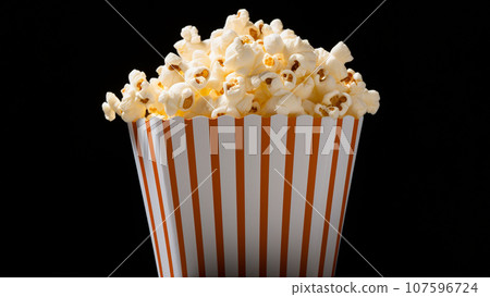Popcorn on a black background. Delicious snacks. 107596724