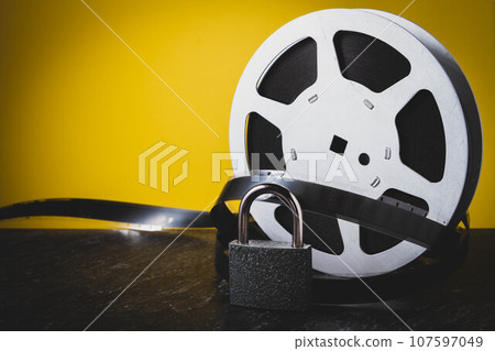 Old film. Cinema on reel. Analog cinema. Movie on cassette. Old film. Cinema on reel. Analog cinema. Movie on cassette. 107597049