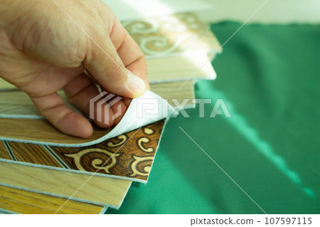 A piece of linoleum for samples. Sliced wood grain linoleum. A piece of linoleum for samples. Sliced wood grain linoleum. 107597115