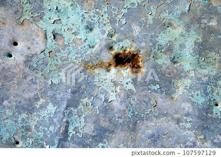 Cracked paint on the iron. Grunge texture on an iron sheet of metal. 107597129