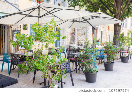 Open cafe restaurant in a small French village 107597974