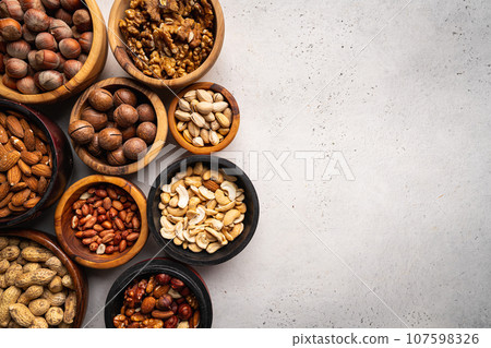 Assortment of nuts in bowls 107598326