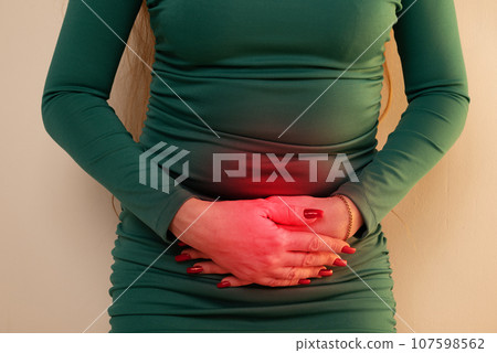 Menstrual pain, woman with stomachache suffering from pms , endometriosis, cystitis and other diseases of the urinary system, painful area highlighted in red 107598562